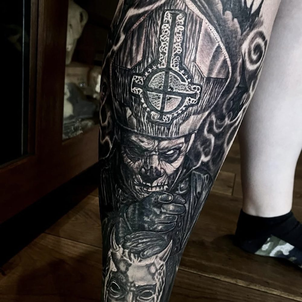 Image of a leg tattoo featuring papa emeritus from the band Ghost in black and grey by Jimbo