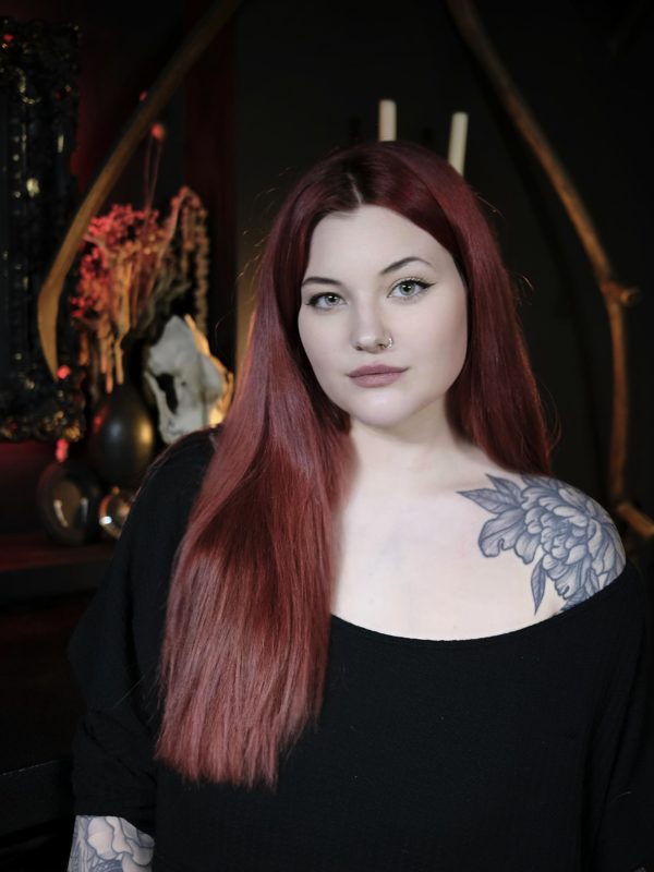 Image shows a portrait photograph of liv valentine tattoo artist in one for sorrow tattoo studio