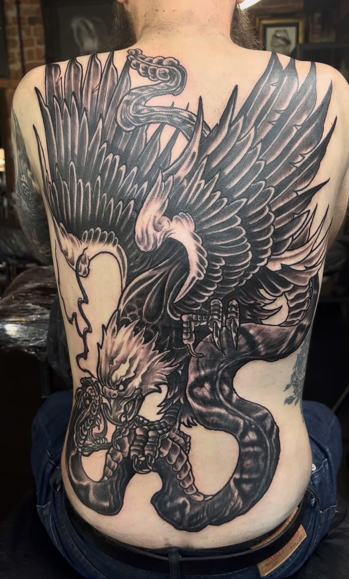 jimbo-eagle-snake-freehand an image of a full back tattoo featuring an eagle attacking a snake