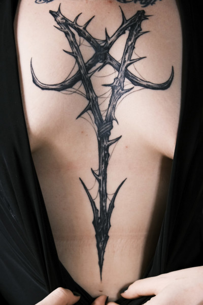 image of a tattoo on a ladies chest and sternum