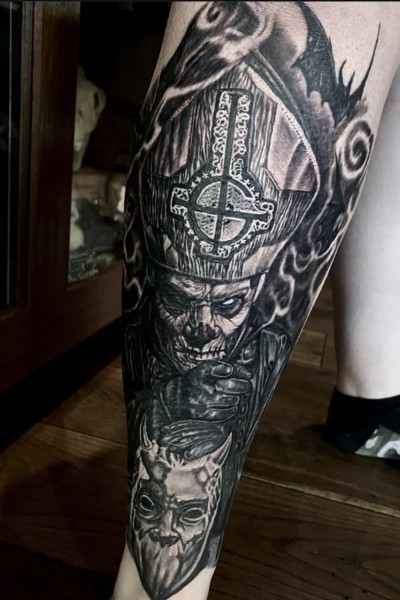 Image of a leg tattoo featuring papa emeritus from the band Ghost in black and grey by Jimbo