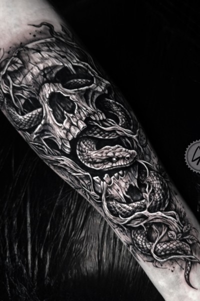 A tattoo of a skull and snake