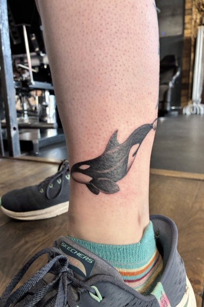 an image of an orca tattoo on a clients ankle